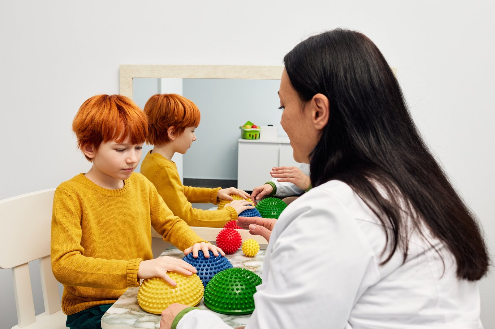 Occupational therapist using sensory integration therapy to improve sensory processing for male